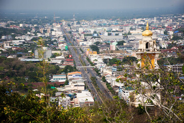 Fototapeta na wymiar Aerial view landscape cityscape of Ratchaburi city and house home with traffic road and life lifestyle local thai people at Khao Kaen Chan hill top viewpoint on April 29, 2023 in Ratchaburi, Thailand