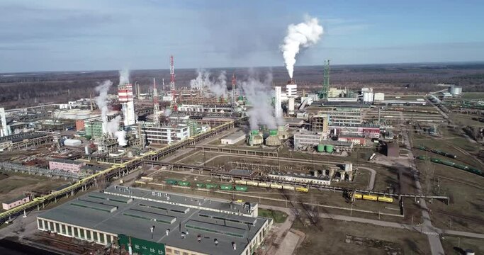 Chemistry Factory in Lithuania, Achema in Jonava City. Clear Blue Sky and Smoke Stacks in Background. Drone