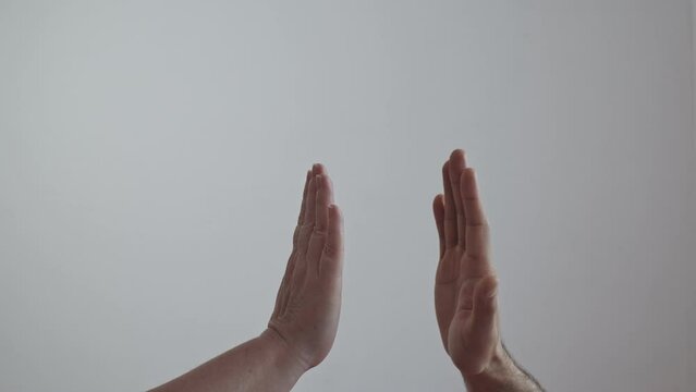High five hand gesture. Performed by a man and a woman