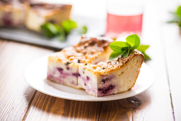 cooked cottage cheese casserole with berry filling in a plate