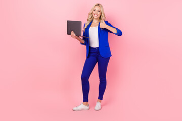 Photo of business lady browse small netbook raise thumb finger up wear smart casual outfit isolated pink color background