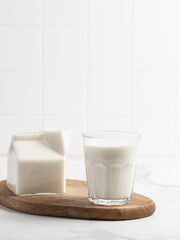 Glass of milk on a light background. Stylish kitchen background.