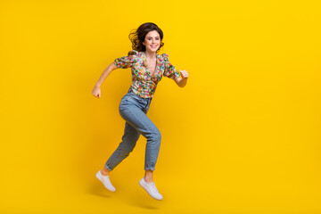 Full body size photo of running motivation young woman wear spring time outfit explore environment isolated on yellow color background