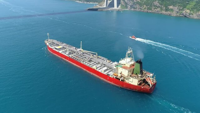 Oil chemical tanker underway straits. Annually 10K tankers pass through where currents caused ships to drift sideways. Tracking shot of a 182 meters long tanker ship