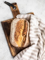 Freshly baked bread with a crispy crust on a light background.