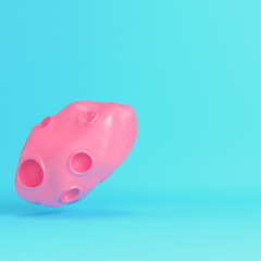 Pink cartoon style asteroid with craters on bright blue background in pastel colors