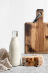 Bottle of milk, fresh bread, light background. Modern kitchen.