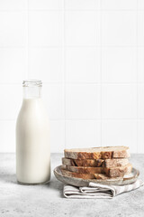 Bottle of milk, fresh bread, light background. Modern kitchen.