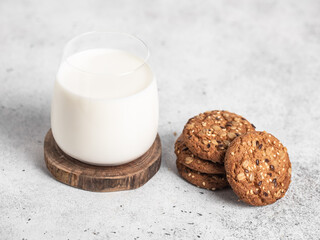Bottle of milk, oatmeal cookies. Light background. Napkin. 