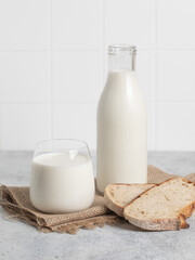 Bottle of milk, fresh bread, light background. Modern kitchen.