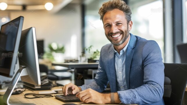 Smiling businessman working at computer in office