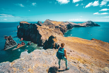Sporty woman enjoys the view of the beautiful foothills of the island. São Lourenço, Madeira...