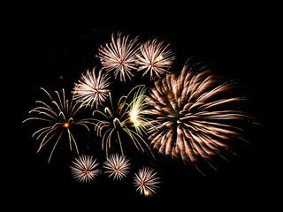 Multiple fireworks against the deep black sky. Bright  display of the fireworks