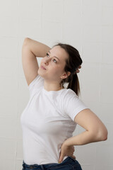 Young cute plump woman posing for the camera with her hand behind her back