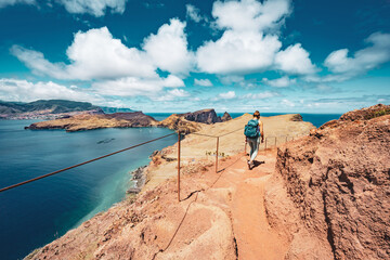 Athletic woman hikes along hike trail with scenic view on the beautiful Madeiran island. São Lourenço, Madeira Island, Portugal, Europe.