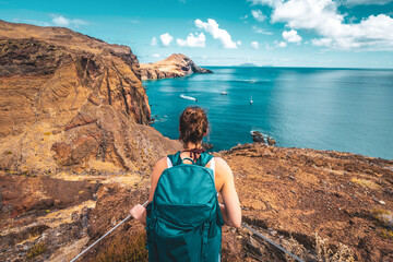 Sporty woman enjoys the picturesque view of the beautiful foothills of Madeira Island. São...