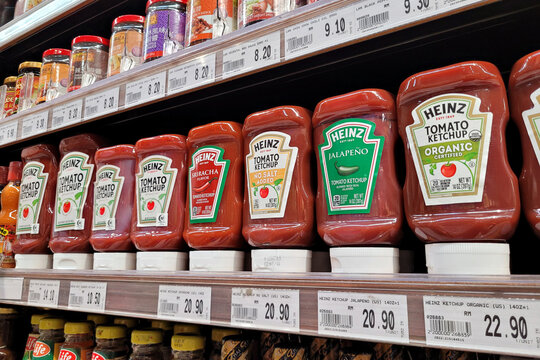 PENANG, MALAYSIA - 3 MAY 2023: A grocery store features a diverse selection of Heinz brand ketchup options on display. Heinz Company was founded by American entrepreneur Henry John Heinz.