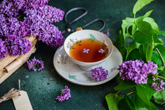 Tasty black tea in vintage cup on mint green concrete table