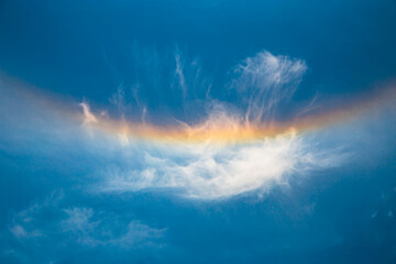  Halo  rainbow after the rain. Dramatic nature background. Colorful rainbow against blue sky