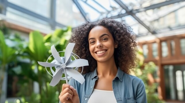 Female engineer with wind turbine model