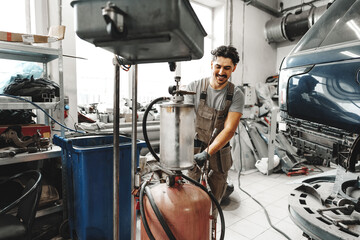 Portrait of an automechanic at work in car service