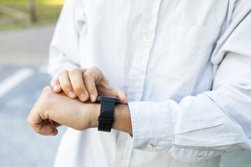 Crop man with smart watch on the street