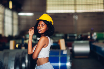 Portrait African American women worker standing in factory industry workplace. Female worker posing confidently while standing in factory workshop