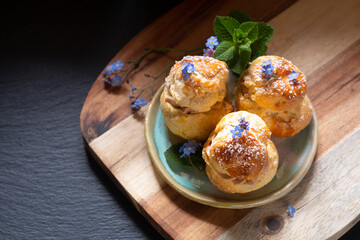 Food concept Spot focus homemade Choux puff Praline on black background with copy space