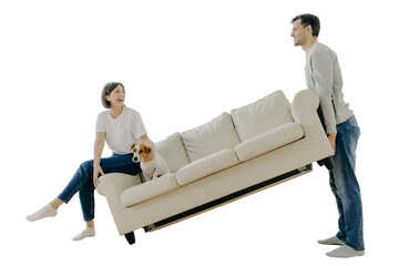 Couple furnishing first home, carrying sofa, playful woman with pet, in living room. Home...