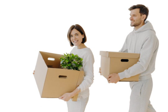 Family couple moving into new home with big boxes, busy unpacking belongings. Happy homeowners embracing domestic routine