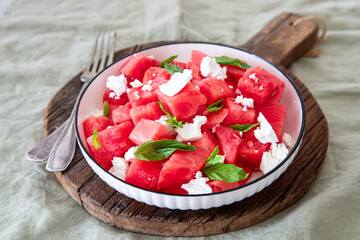 Summer salad of watermelon, feta cheese and fresh mint leaves .