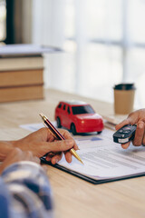 Car dealerships and customers sign car insurance documents or rental paper. Planning to manage...