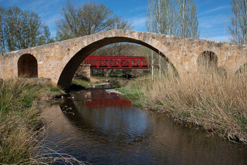 Fototapeta na wymiar roman bridge with railway bridge on the background