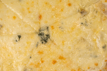 Four cheese pizza as a background.