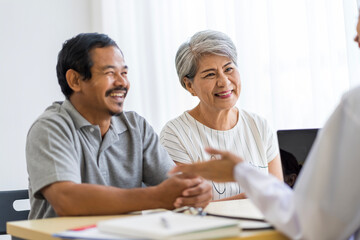 Asian seniors who are healthy, in a good mood, smiling, talking with financial or life insurance staff to take care of life after retirement.