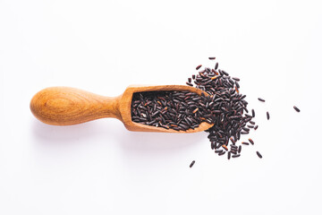 Raw black rice in the wooden spoon