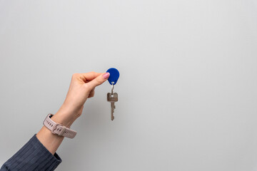 Woman holding keys with a flower in the background, suggesting the concept of an eco-friendly home that utilizes renewable energy sources. Concept related to environmentalism, renewable energy, sustai