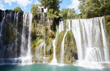 Fototapeta premium The Gorgeous Pliva Waterfall in Scenic Jajce, Bosnia and Herzegovina