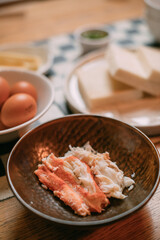 Kamchatka crab meat as an ingredient of a dish on the kitchen table.