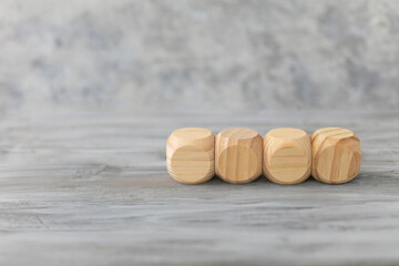 Fototapeta na wymiar Business design concept. Four abstract geometric wooden blank dice isolate on white rustic surface.