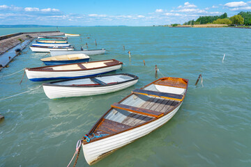 Fototapeta na wymiar pier in Balatonlelle with colorful boats on lake Balaton blue sky and water