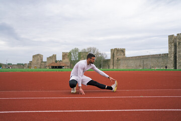 Fototapeta premium Man Warming Up and Stretching Before Workout and Running