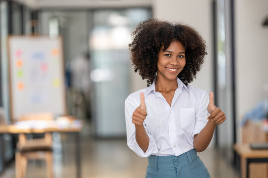 smiling business woman showing fingers thumb up by two hands, Both thumbs up showing appreciation
