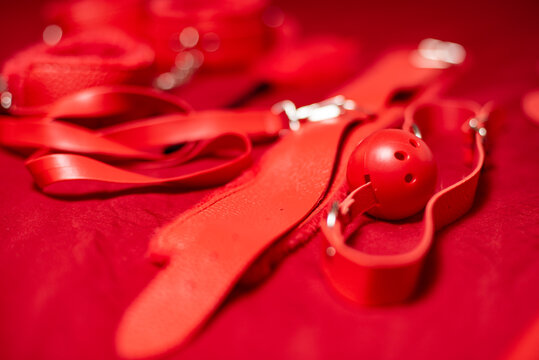 Red Bondage Gear on Red Satin Sheets, Shallow Focus