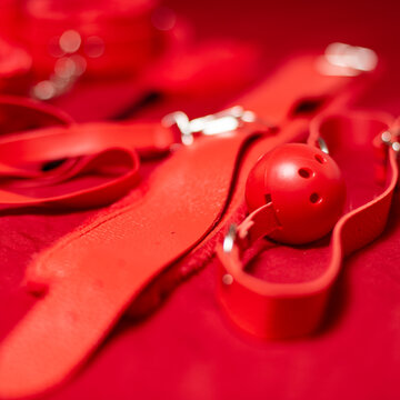 Red Bondage Gear on Red Satin Sheets, Shallow Focus