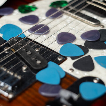 Guitar Picks Scattered on Guitar Body