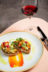 Italian bruschetta with roasted tomatoes, mozzarella cheese and herbs