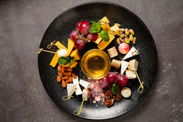 cheese plate with honey and grapes