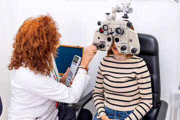 Optician and optometrist. Eye doctor helps his patient.