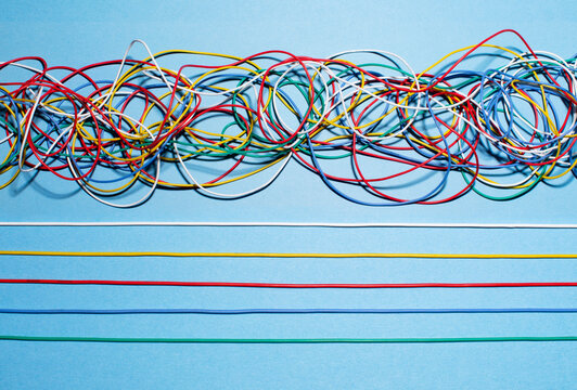 Straight and tangled multi colored wires, view from above